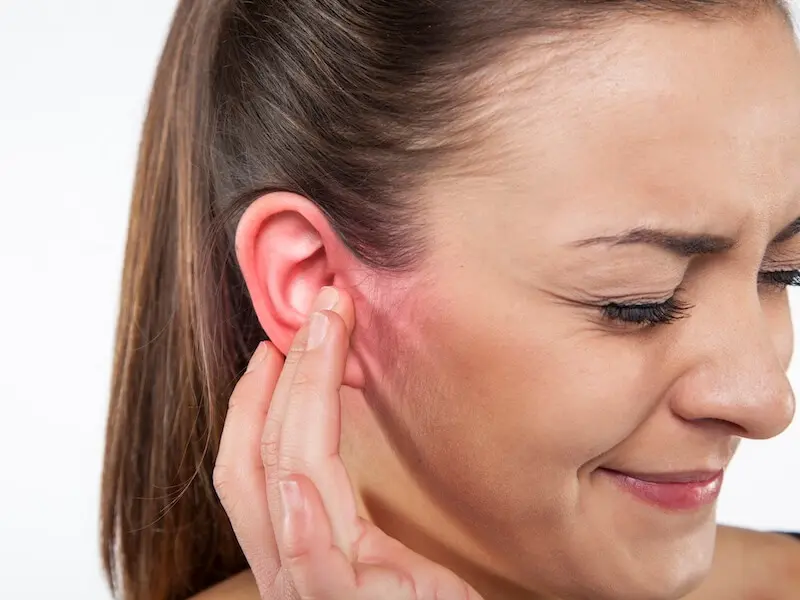 Girl pressing on sore ear