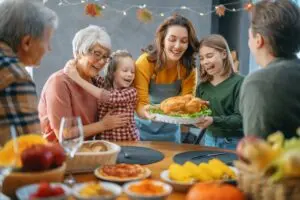 Happy family sitting at table and celebrating Thanksgiving