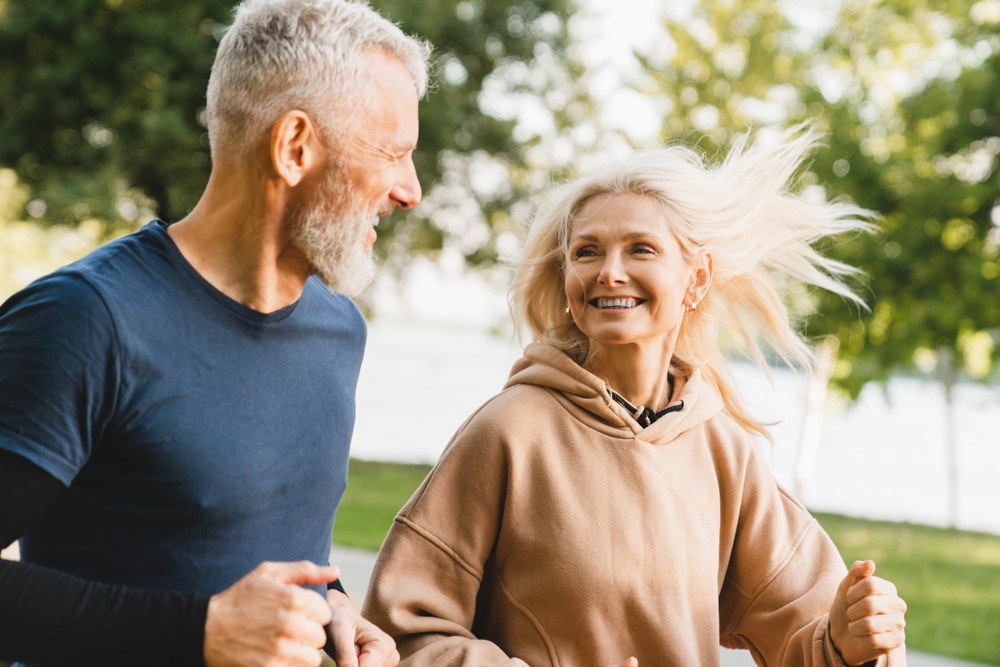 Mature,Middle,Aged,Senior,Couple,Running,Together,In,The,Park